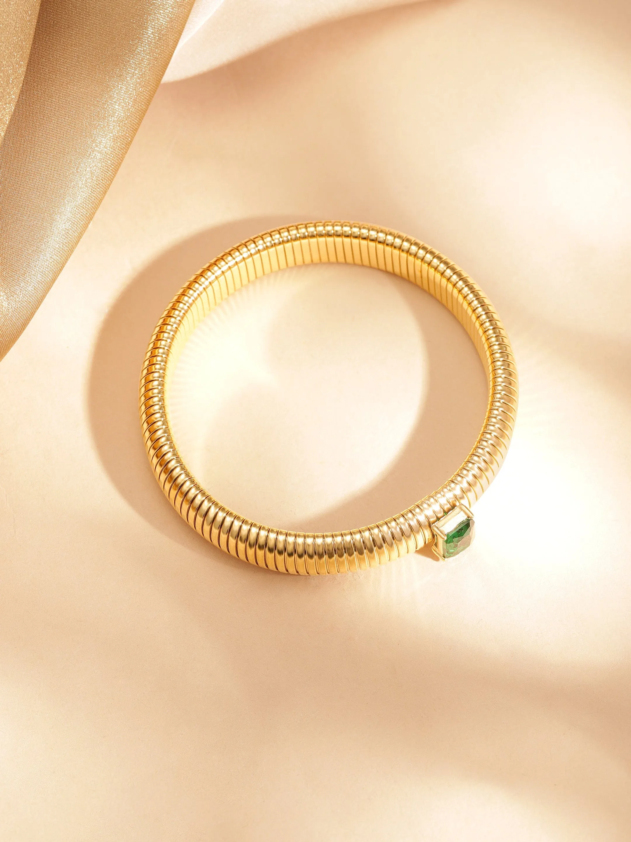 Rubans Voguish 18k Gold Plated  water proof Stainless Twilight Spiral  of shimmer  with Green stone bracelet